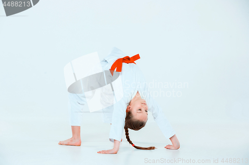 Image of The girl posing at Aikido training in martial arts school. Healthy lifestyle and sports concept