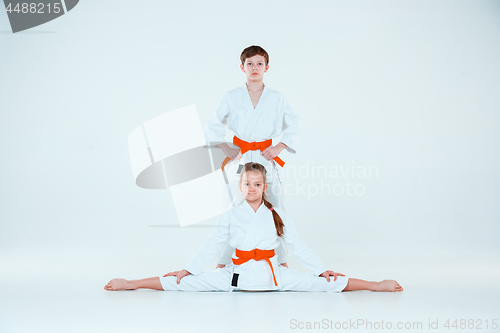 Image of The boy and girl posing at Aikido training in martial arts school. Healthy lifestyle and sports concept