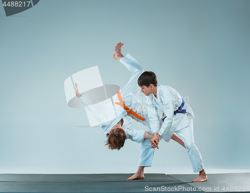 Image of The two boys fighting at Aikido training in martial arts school. Healthy lifestyle and sports concept