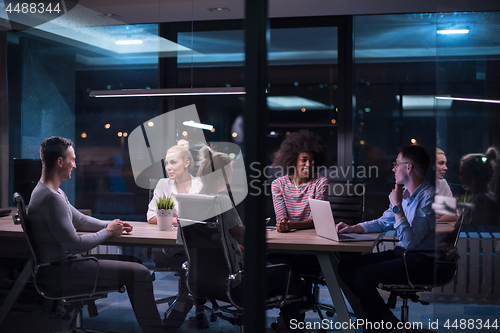 Image of Multiethnic startup business team in night office