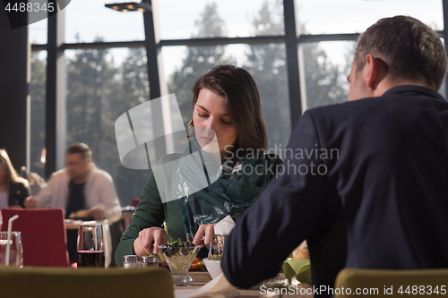Image of Closeup shot of young woman and man having meal.