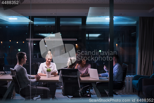 Image of Multiethnic startup business team in night office