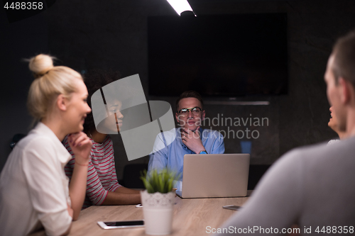 Image of Multiethnic startup business team in night office
