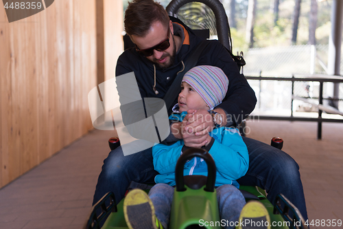 Image of father and son enjoys driving on alpine coaster