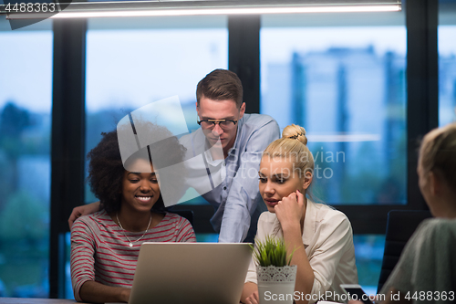 Image of Multiethnic startup business team in night office