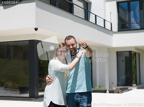 Image of couple hugging in front of  new luxury home