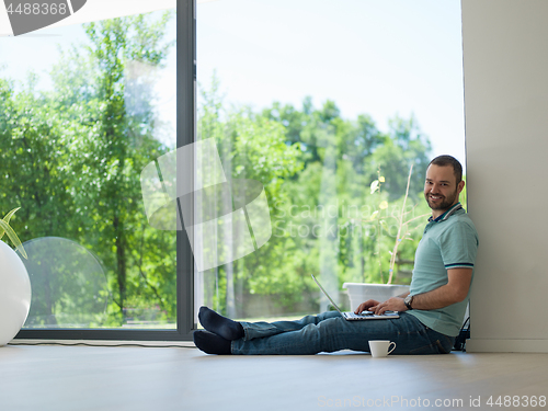 Image of man drinking coffee on the floor enjoying relaxing lifestyle