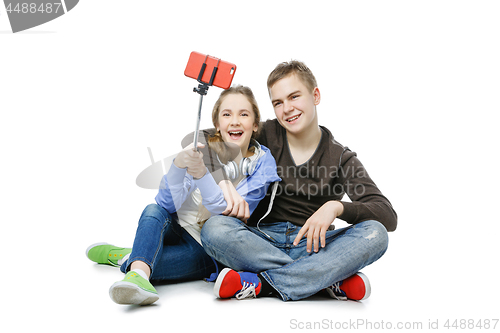 Image of Teen boy and girl taking selfie photo