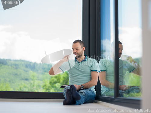 Image of man on the floor enjoying relaxing lifestyle