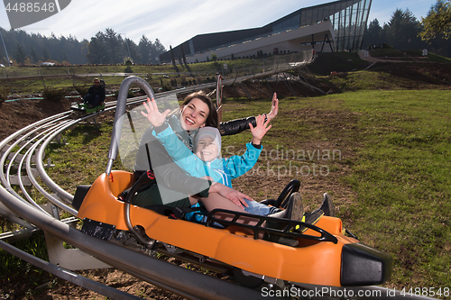 Image of mother and son enjoys driving on alpine coaster