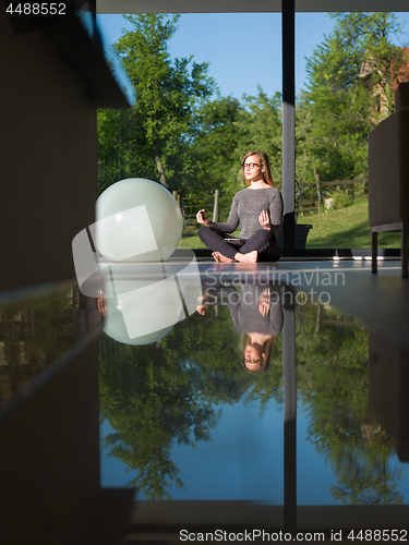 Image of young woman doing morning yoga exercises