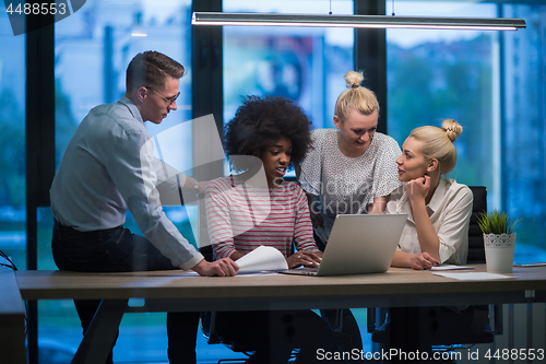 Image of Multiethnic startup business team in night office