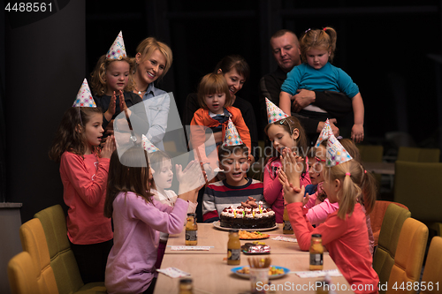 Image of The young boy joyfully celebrating his birthday