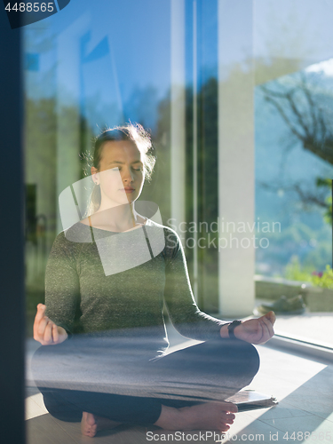 Image of young woman doing morning yoga exercises