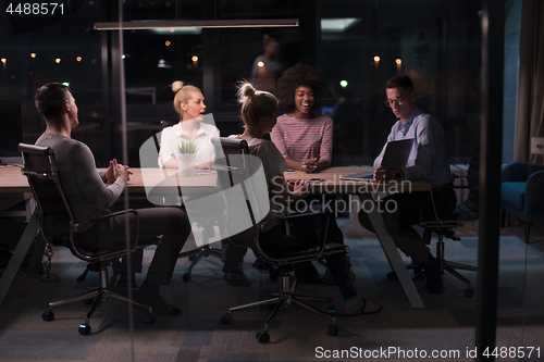 Image of Multiethnic startup business team in night office