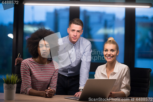 Image of Multiethnic startup business team in night office