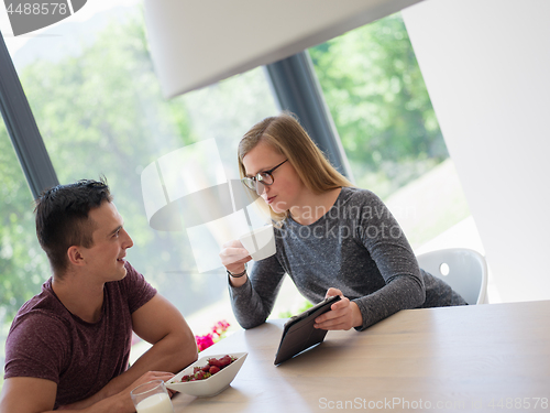 Image of couple enjoying morning coffee and strawberries