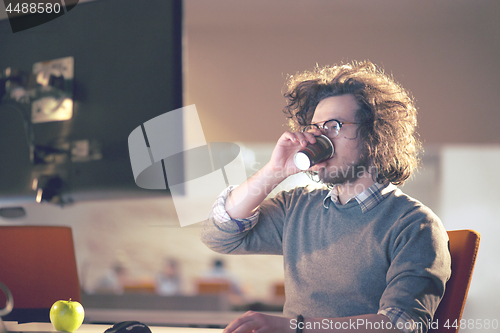 Image of Tired businessman working late