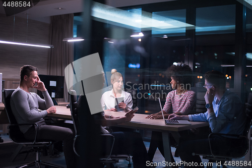 Image of Multiethnic startup business team in night office