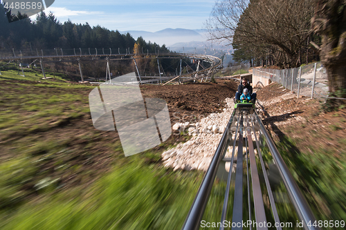 Image of father and son enjoys driving on alpine coaster