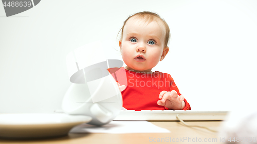 Image of Happy child baby girl toddler sitting with keyboard of computer isolated on a white background