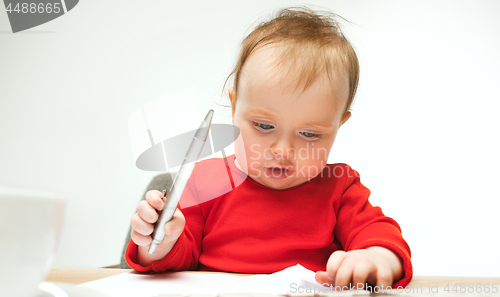 Image of Happy child baby girl toddler sitting with keyboard of computer isolated on a white background