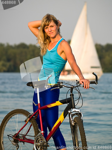 Image of Female cyclist posing outdoors