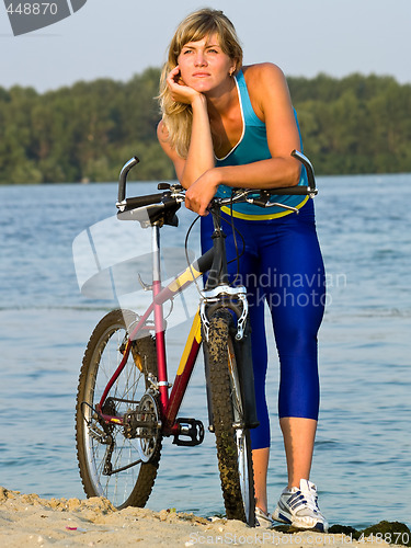 Image of Female cyclist posing outdoors