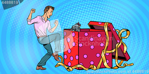Image of Man and dog puppy as a gift holiday box, funny reaction joy