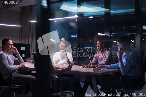 Image of Multiethnic startup business team in night office