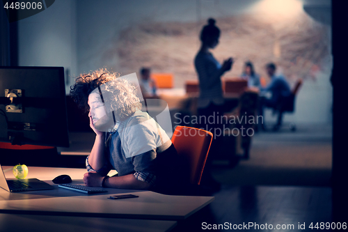 Image of man working on computer in dark office