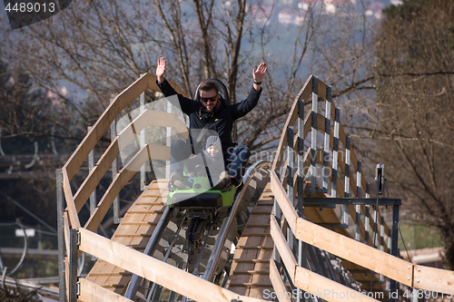 Image of father and son enjoys driving on alpine coaster