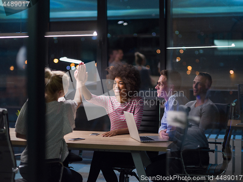 Image of Multiethnic startup business team in night office