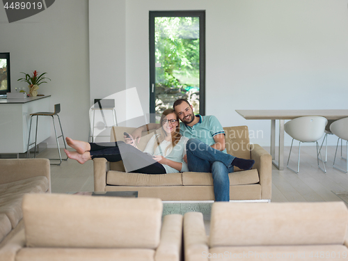Image of Young couple on the sofa watching television
