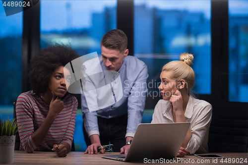 Image of Multiethnic startup business team in night office