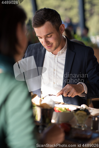 Image of Closeup shot of young woman and man having meal.