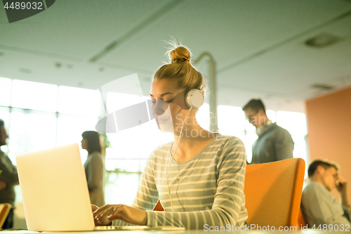 Image of businesswoman using a laptop in startup office