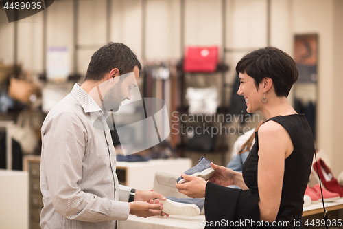 Image of couple chooses shoes At Shoe Store