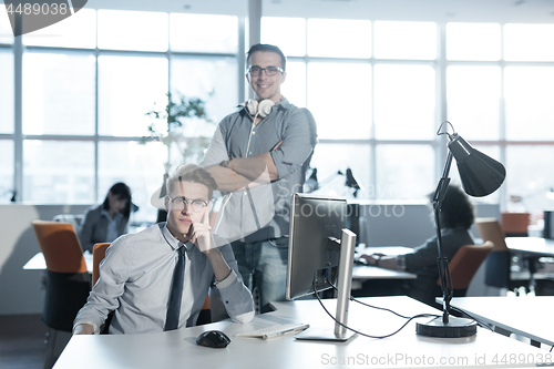 Image of Two Business People Working With computer in office