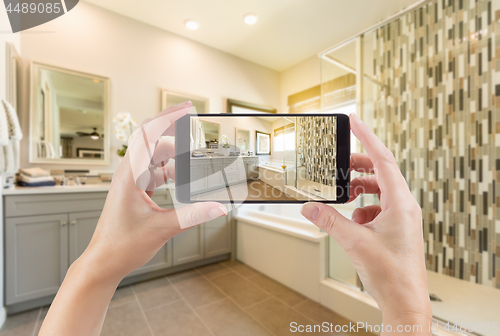 Image of Master Bathroom Interior and Hands Holding Smart Phone with Phot