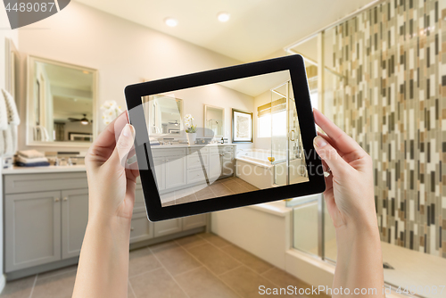 Image of Master Bathroom Interior and Hands Holding Computer Tablet with 