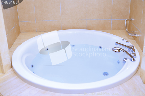 Image of Modern bathtub full of water