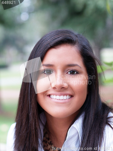 Image of Outdoor portrait of young hispanic teen girl