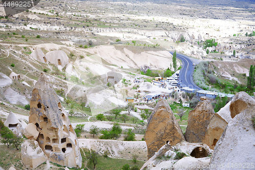 Image of Travel bus station with crowd of people in rocky valley of Cappa