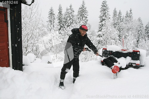 Image of Man shoveling snow