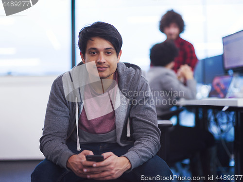 Image of software developer using mobile phone