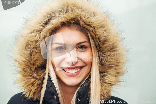 Image of portrait of young blonde girl wearing winter jacket