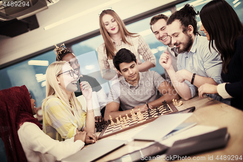 Image of multiethnic group of business people playing chess