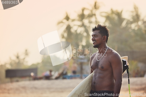 Image of Portrait of surfer at sunset