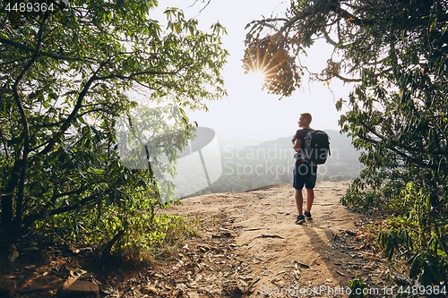 Image of Hiker overlooking view from rock